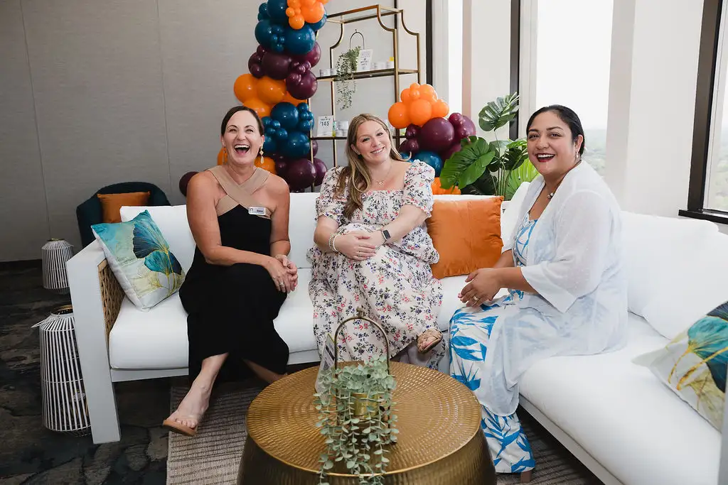 Three woman sitting on sofa at a coworking day